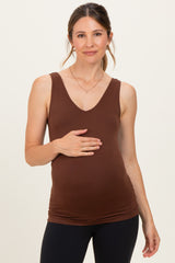 woman wearing a brown maternity tank top and holding her baby bump