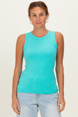 woman wearing a turquoise sleeveless ribbed tank top and light blue jeans
