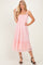 woman wearing a pink lace midi dress with spaghetti straps and a ruffled hem