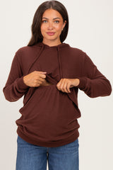 woman wearing a brown maternity hoodie with lifting front for easy nursing access and blue jeans, showing her baby bump