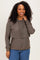 woman wearing a dark gray layered hoodie with a front flap and long sleeves paired with blue jeans