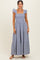 woman wearing a blue and white gingham maxi dress with ruffled shoulder straps and tiered skirt