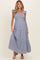 woman wearing a navy and white gingham maternity maxi dress with ruffle sleeves and tiered skirt