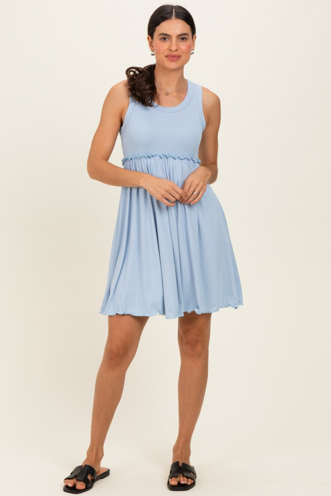 woman wearing a light blue sleeveless dress with a fitted bodice and flared skirt