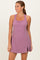 woman wearing a lavender sleeveless athletic dress with side slits and a fitted bodice