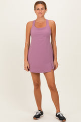 woman wearing a sleeveless lavender athletic dress with a side slit and a fitted silhouette