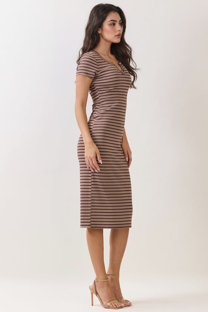 woman wearing a fitted brown and cream striped midi dress with short sleeves and a scoop neckline