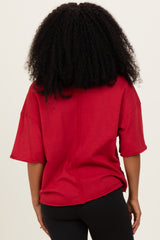 woman wearing a red oversized short sleeve top with a relaxed fit and back seam detail