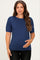 woman wearing a navy short sleeve maternity top and holding her baby bump