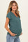 woman wearing a teal v-neck maternity top with short sleeves and a visible baby bump