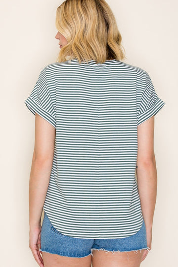 woman wearing a striped short sleeve top with rolled cuffs and denim shorts, shown from the back