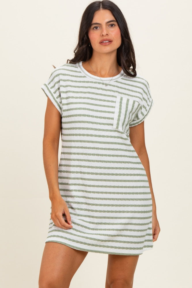woman wearing a green and white striped short sleeve dress with a pocket on the chest