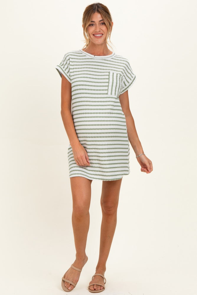 woman wearing a striped short sleeve maternity dress with a pocket in a light green color