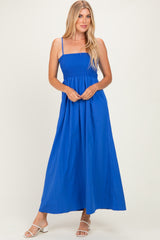 woman wearing a bright blue maxi dress with smocked bodice and spaghetti straps