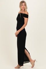 woman wearing a black off-the-shoulder maxi dress with a side slit and clear heeled sandals