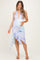 woman wearing a halter neck pastel print maternity dress with a ruffled hem and holding her baby bump