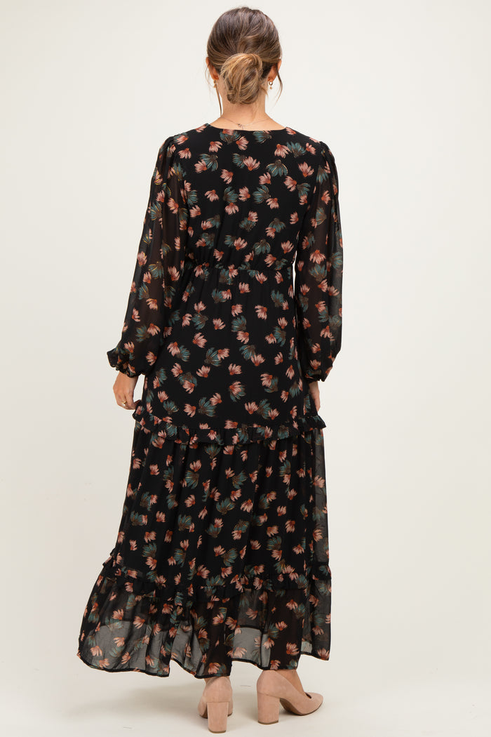 woman wearing a black floral long sleeve maternity maxi dress, seen from the back