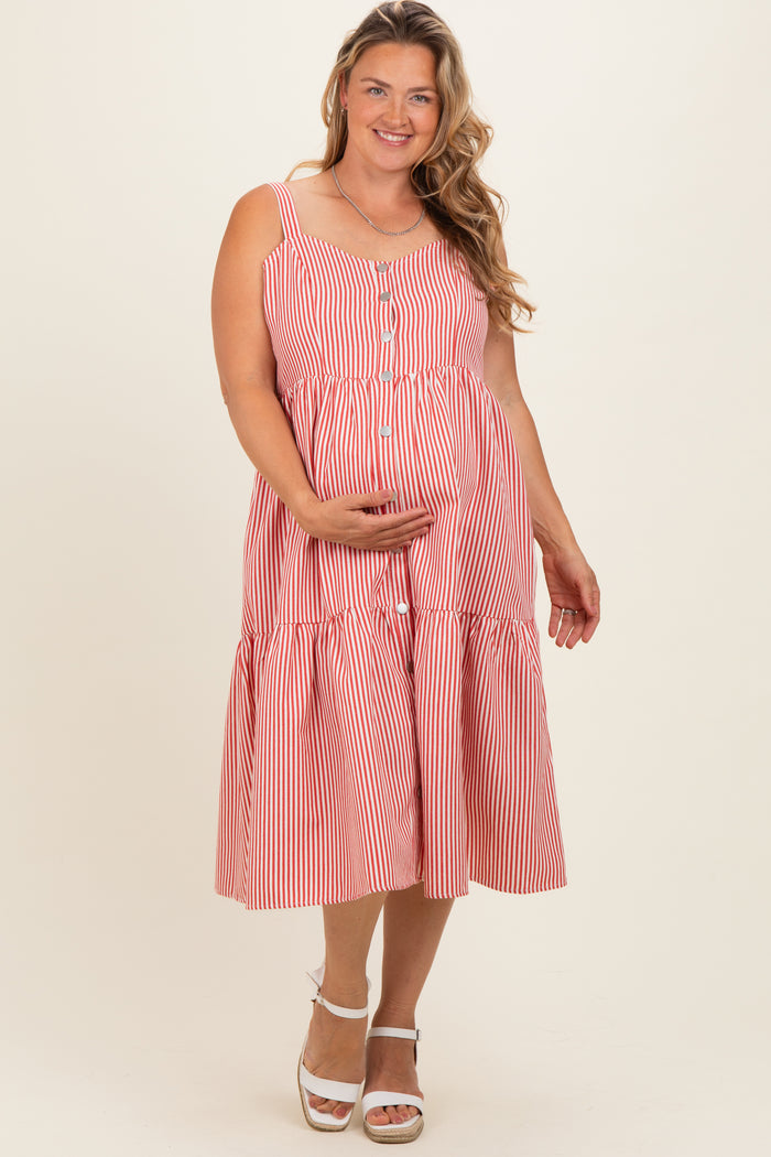 woman wearing a red and white striped maternity plus dress with buttons and a tiered skirt, showcasing her baby bump