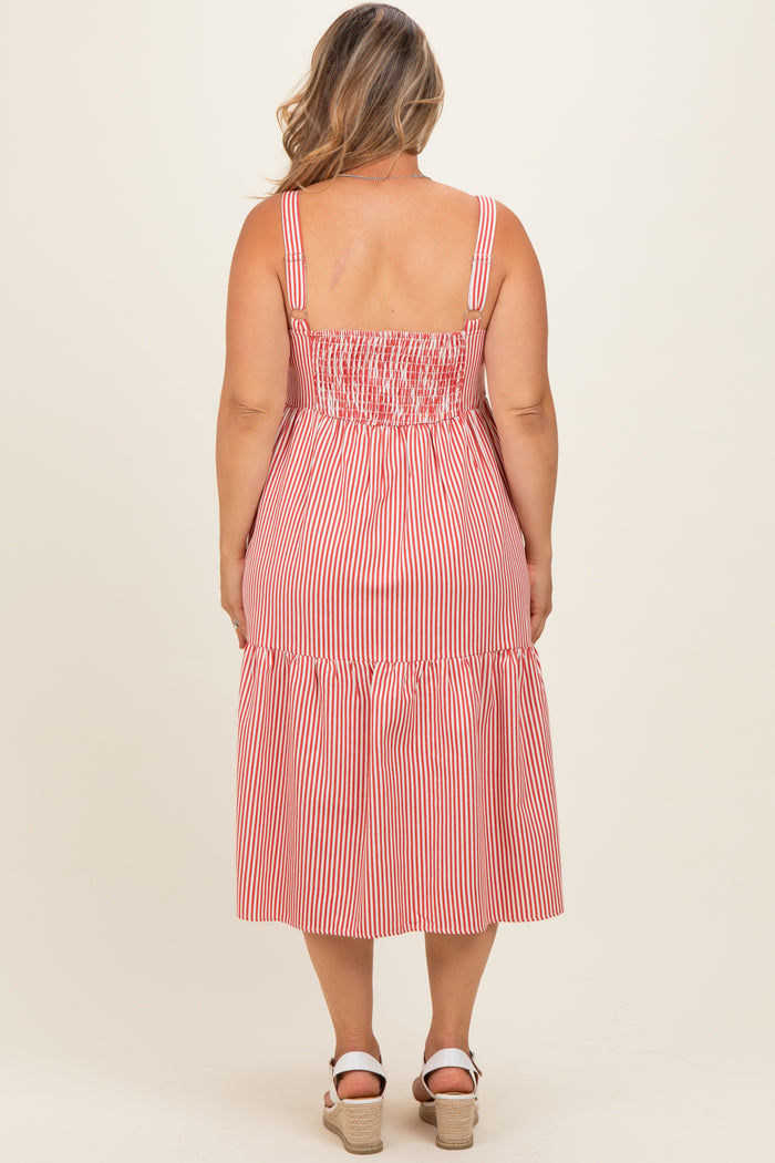 woman wearing a red and white striped maternity plus dress with a smocked bodice and tiered skirt, styled for summer