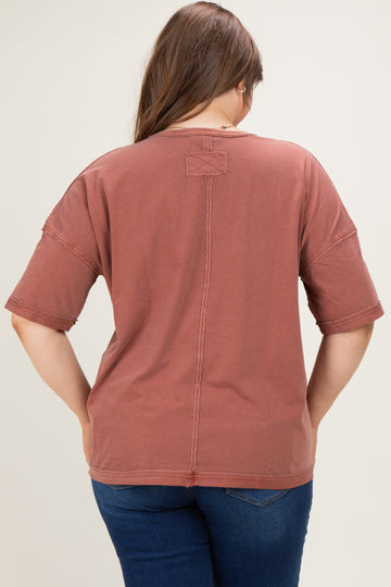 woman wearing a rust-colored maternity plus oversized t-shirt, viewed from the back, with casual style details