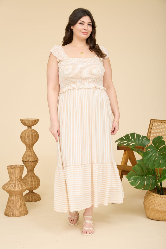 plus size woman wearing a light beige and cream striped maxi dress with ruffled sleeves and tiered hem