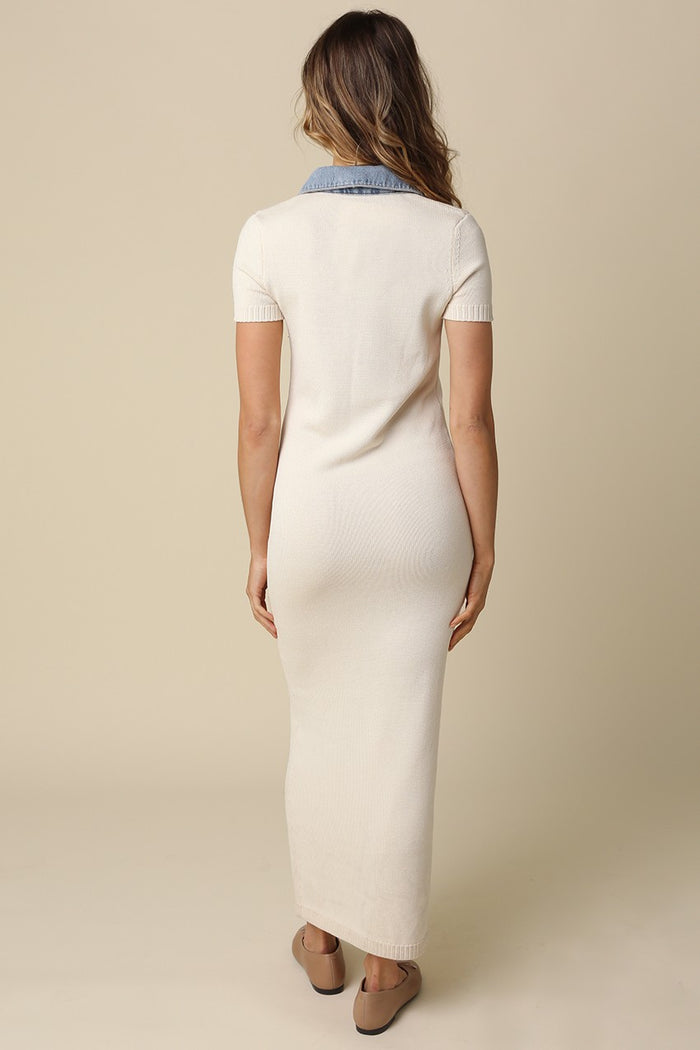 woman wearing a cream-colored maxi dress with a denim collar, viewed from the back