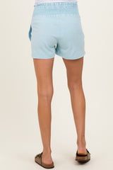 woman wearing light blue maternity shorts with an elastic waistband, seen from the back