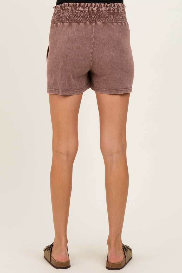 woman wearing mauve maternity shorts with smocked waistband, showing the back view