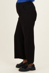 woman wearing black maternity wide-leg pants with an elastic waistband and visible baby bump