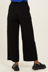 woman wearing black wide-leg maternity pants, shown from the back