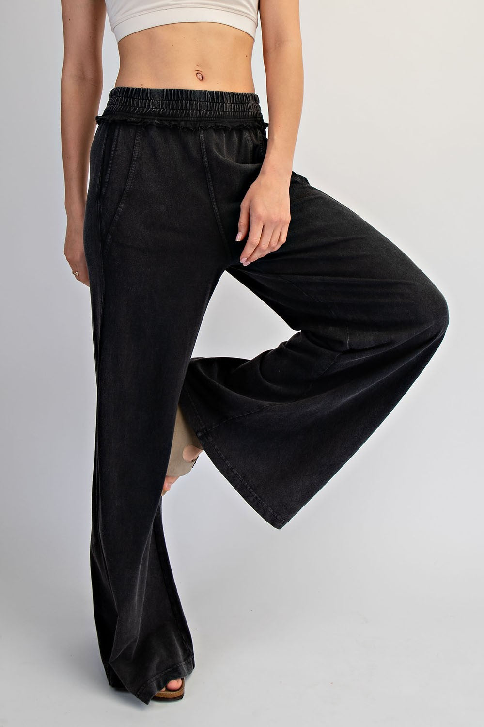 woman wearing black wide-leg denim pants with an elastic waistband and a cropped top