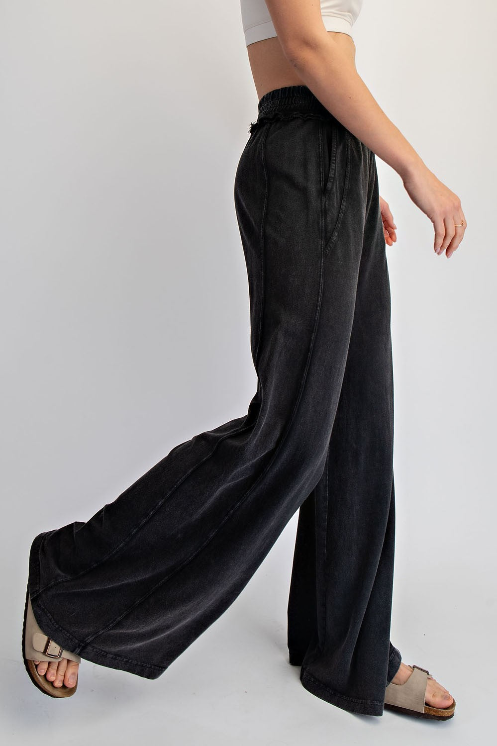 woman wearing black wide-leg denim pants with an elastic waistband and side pockets