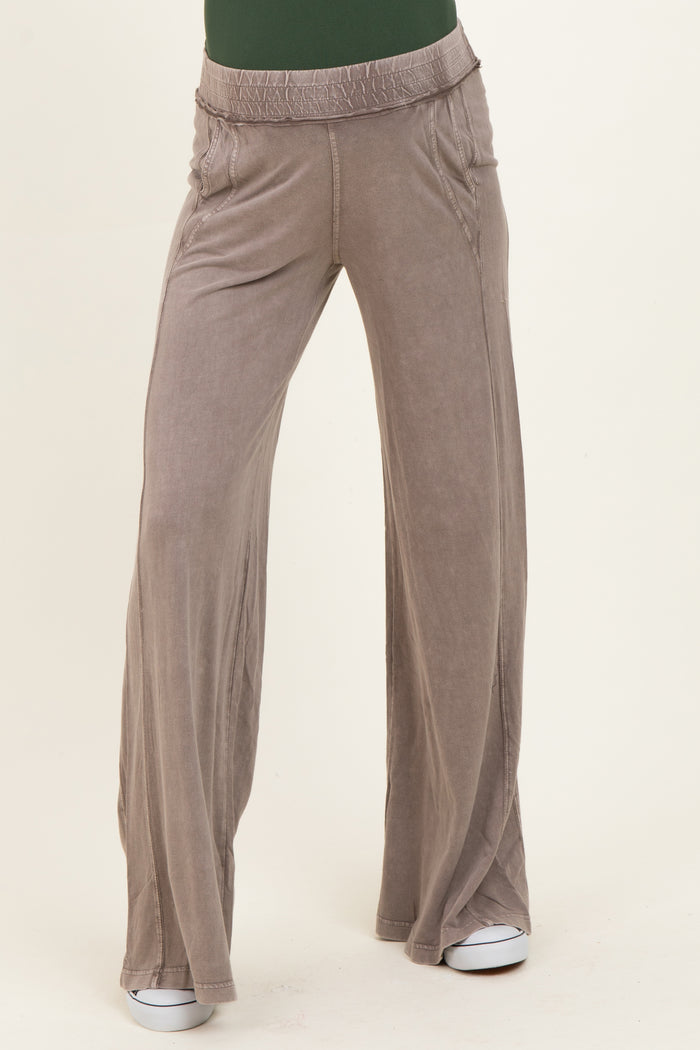 maternity wear in light gray wide-leg pants with an elastic waistband, model standing with a relaxed fit