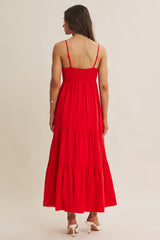woman wearing a red smocked back maxi dress with a tiered skirt and spaghetti straps