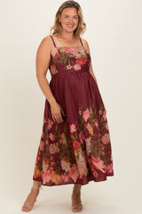 woman wearing a burgundy floral maxi dress with spaghetti straps, styled for maternity plus wear