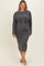 woman wearing a dark gray ribbed maternity sweater dress with a tie waist and a visible baby bump
