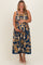 woman wearing a navy blue floral print maternity dress with spaghetti straps and holding her baby bump