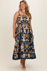 woman wearing a navy blue floral print maternity plus maxi dress with adjustable straps and a flowing silhouette