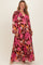 woman wearing a maternity plus floral wrap maxi dress with long sleeves and a deep V-neckline