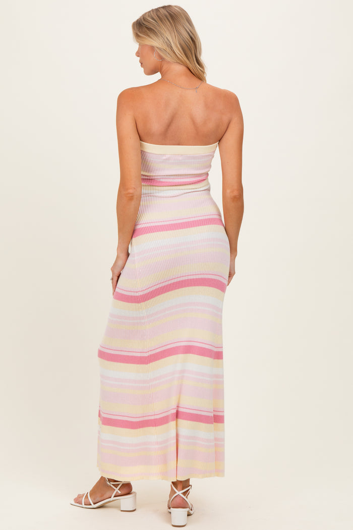 woman wearing a strapless pastel striped maternity maxi dress, showing a fitted silhouette and ankle-length style