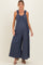 woman wearing a navy blue maternity jumpsuit with ruffled straps and wide-leg design, showcasing her baby bump