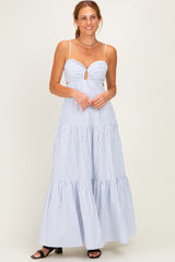 woman wearing a white and blue striped maxi dress with a keyhole detail and tiered skirt