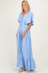 woman wearing a light blue maxi dress with flutter sleeves and a tie-front detail