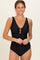 woman wearing a black maternity swimsuit with a keyhole cutout at the bust and a ruched midsection