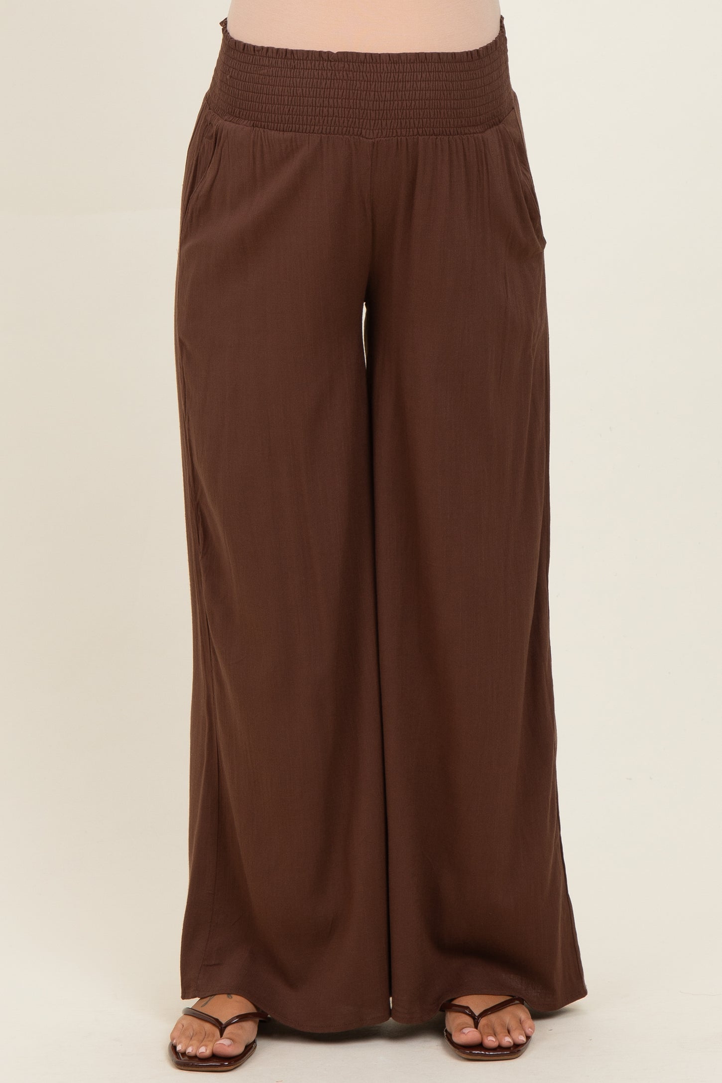 maternity wide leg brown pants with smocked waistband, featuring side pockets and a relaxed fit