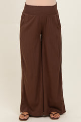 maternity wide leg brown pants with smocked waistband, featuring side pockets and a relaxed fit