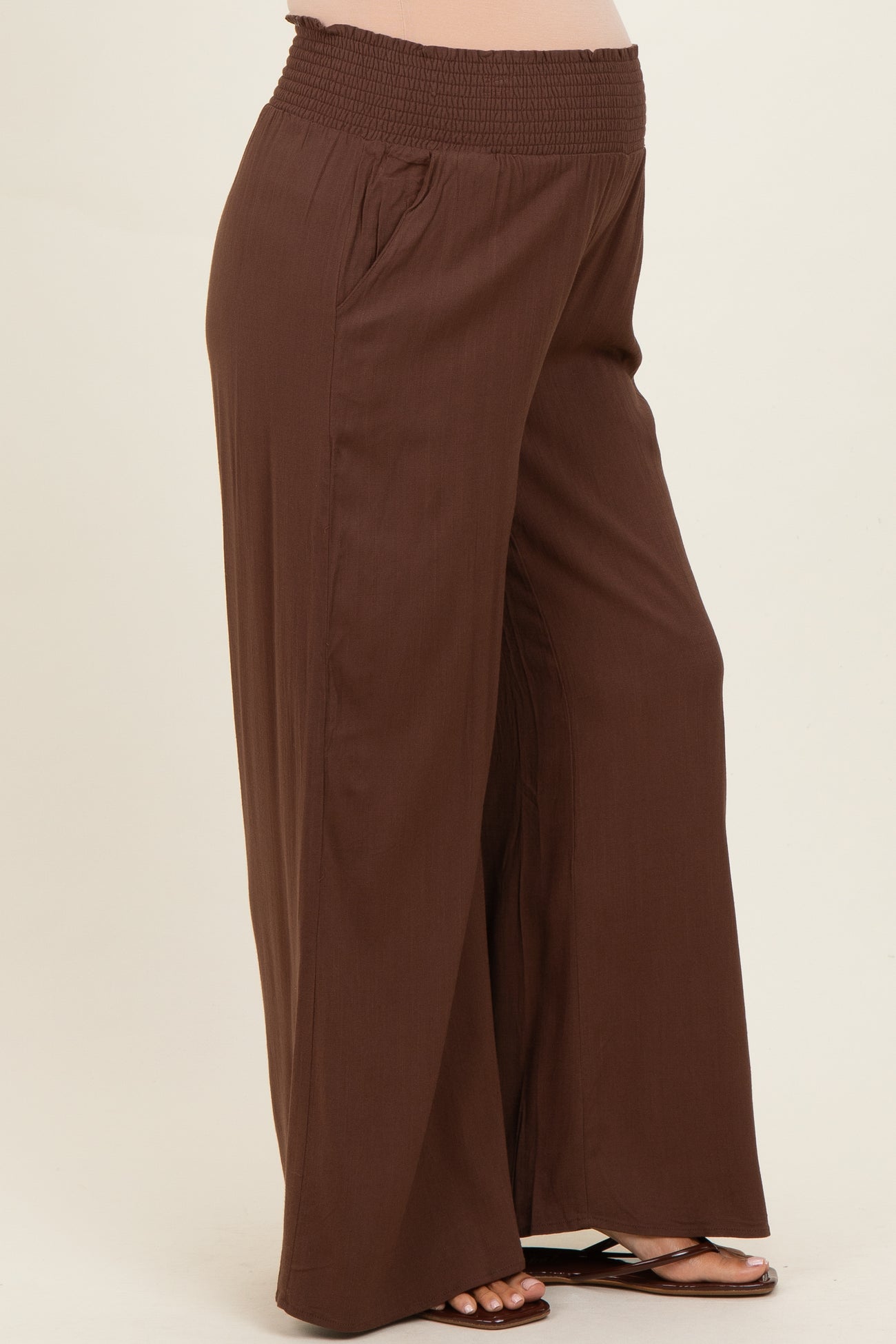 maternity wear brown wide-leg pants with a stretchy smocked waistband and side pockets