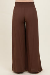 maternity wear in warm brown wide-leg pants with smocked waistband, shown from the back