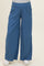 maternity wear blue wide-leg pants with a smocked waistband and side pockets, model wearing them with a gray top