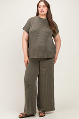 woman wearing a dark olive green ribbed maternity plus size lounge set with short sleeves and wide-leg pants